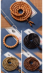 Detailed comparison of 8mm sandalwood and ebony Buddhist prayer beads with 108 beads