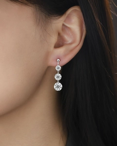 Detailed view of 925 silver dangling earrings with three sparkling moissanite stones