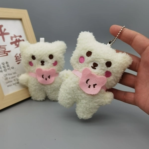 Detail view of cute plush white bear pendants with pink bibs and silver ball chains