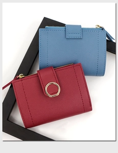 Detail of short wallets with lychee pattern PU leather and golden ring buckle