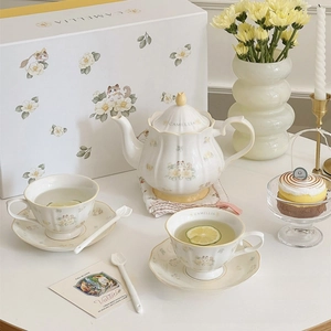 Detailed view of ceramic teapot and cups with camellia cat print in a gift box