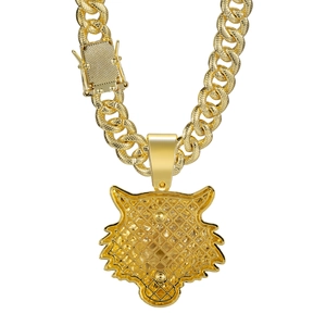 Detailed close-up of golden tiger head pendant with a bold cuban chain and box clasp buckle