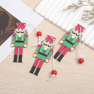 Three colorful wooden nutcracker soldier ornaments with hanging strings for Christmas tree