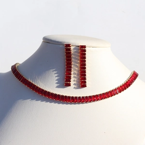 Detail of red crystal necklace and long dangle earrings set on gold base