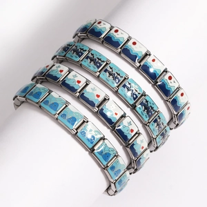 Detail of stainless steel stretch bracelets featuring blue ocean enamel patterns
