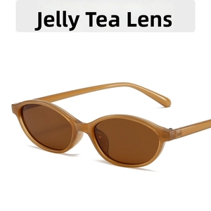 Detail of translucent jelly brown oval sunglasses frames with dark tea colored lenses