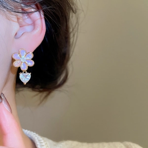 Detailed close-up of pink resin flower earrings with heart-shaped zircon drop pendants