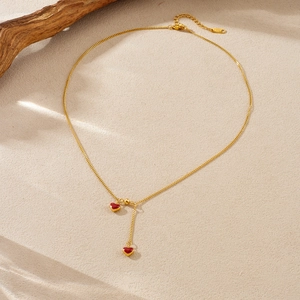 French style gold Y-necklace with burgundy enamel heart pendants and leaf shadows