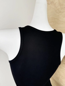 Close-up of black ribbed knit sports vest featuring a racerback design on a mannequin