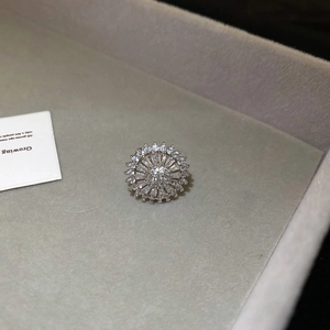 Macro shot of silver zircon flower earring with radiant petals in a grey jewelry box