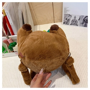 Close-up of a brown capybara plush backpack with adjustable straps and metal buckles