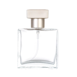 Square clear glass perfume spray bottle with beige cap on white background