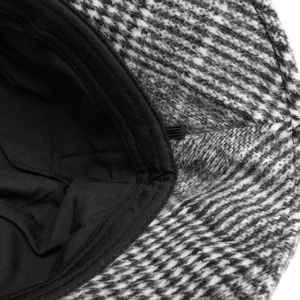 Close-up detail of vintage houndstooth woolen bucket hat showing inner black lining