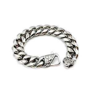 Detail of polished stainless steel Cuban link bracelet with a detailed dragon head clasp