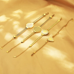 Detail of four 18K gold-plated titanium steel bracelets with geometric charms and shell inlays