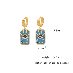 Detailed view of bohemian stainless steel blue enamel earrings with moon and eye patterns