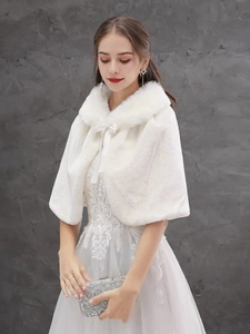Detail of white faux fur bridal shawl with soft collar and tie closure for winter weddings