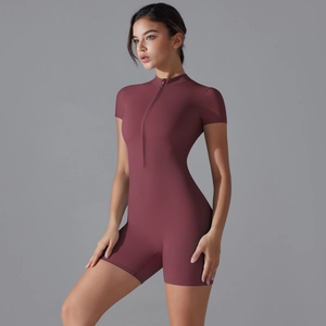 Close-up of a women's dark red short sleeve yoga romper with front zipper detail