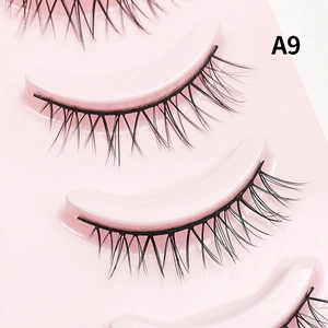 Close-up of A9 natural black false eyelashes neatly arranged in a pink plastic tray