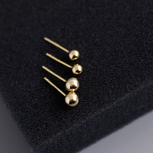 Macro shot of four polished 18K gold-plated S925 sterling silver ball stud earrings