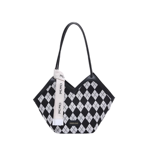 Chic black and white argyle tote bag with leather straps and decorative ribbon detail