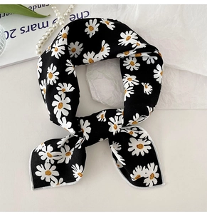 Detail of floral daisy print on narrow black cotton linen scarf with fine stitched edges