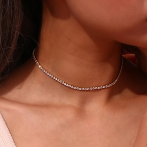 Detail of 14K gold plated chain necklace with micro-pave cubic zirconia on model