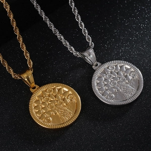 Detailed shot of tree of life pendants in gold and silver finish with twist chains