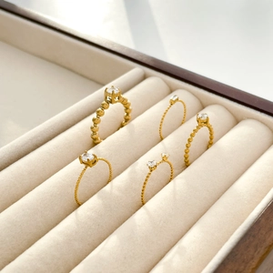 Elegant 18K gold plated twisted beaded ring set with cubic zirconia in a jewelry box