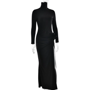 Detail of elegant black high neck dress featuring a 3D floral accent and side ruching