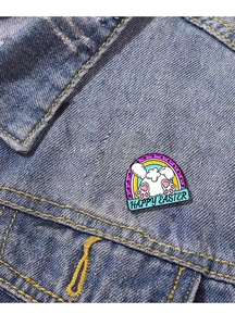 Detail of bunny butt enamel pin with Happy Easter banner on a denim jacket pocket