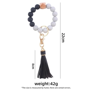 Silicone bead keychain bracelet with black faux leather tassel and gold hardware, 22cm length