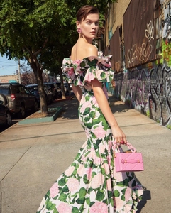 Close-up of pink floral dress with tiered ruffles and elegant mermaid silhouette