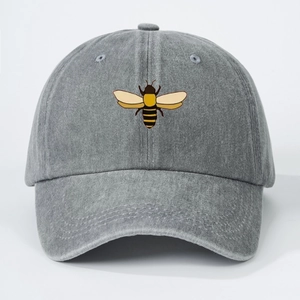 Close-up detail of a dark gray washed cotton baseball cap with a colorful bee embroidery