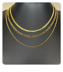 Detailed layered gold necklace set with flat snake, Figaro and circular link chains