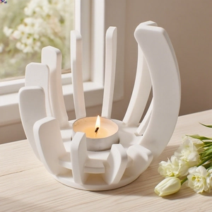 Close-up of modern abstract cage resin candle holder with lit tea light on wooden table