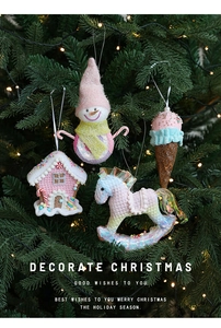 Pink Christmas ornaments with snowman and candy cane details on a festive tree