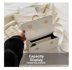 Interior view of white leather crossbody bag showing capacity for phone and wallet