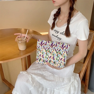 Detail view of floral tulip canvas makeup bag on a cafe table for travel storage