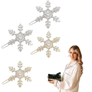 Detail view of sparkling snowflake hair clips in gold and silver finish with rhinestones