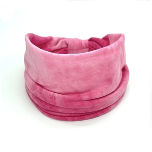 Detailed view of pink tie-dye cotton headband with soft pleated texture on white background