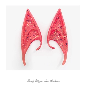 Close-up of sparkling pink glitter elf ears for Halloween cosplay and party dress-up