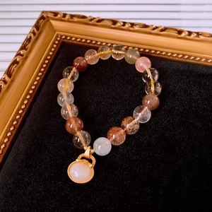 Detailed macro of crystal beads and white jade pendant on a vintage gemstone bracelet