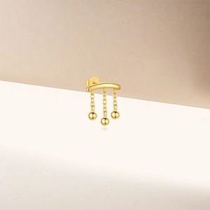 Detailed macro shot of S925 sterling silver stamp on golden triple bead tassel earrings