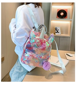 Close-up of rainbow sequin unicorn backpack for girls with purple pom pom and silver horn