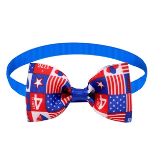 Detail view of July 4th pet bowtie featuring USA flag patterns and 1776 date print