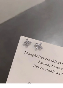 Macro detail of silver magnetic flower stud earrings with marquise-cut cubic zirconia