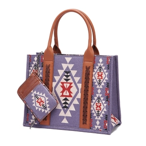 Detail of purple geometric fabric tote with brown leather handles and matching purse