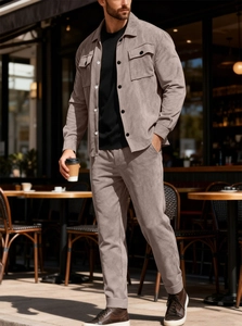 Detailed view of taupe suede tracksuit featuring chest pockets and straight-leg cut