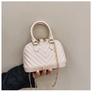 Detailed close-up of pink jelly handbag featuring V-quilted texture and gold chain strap